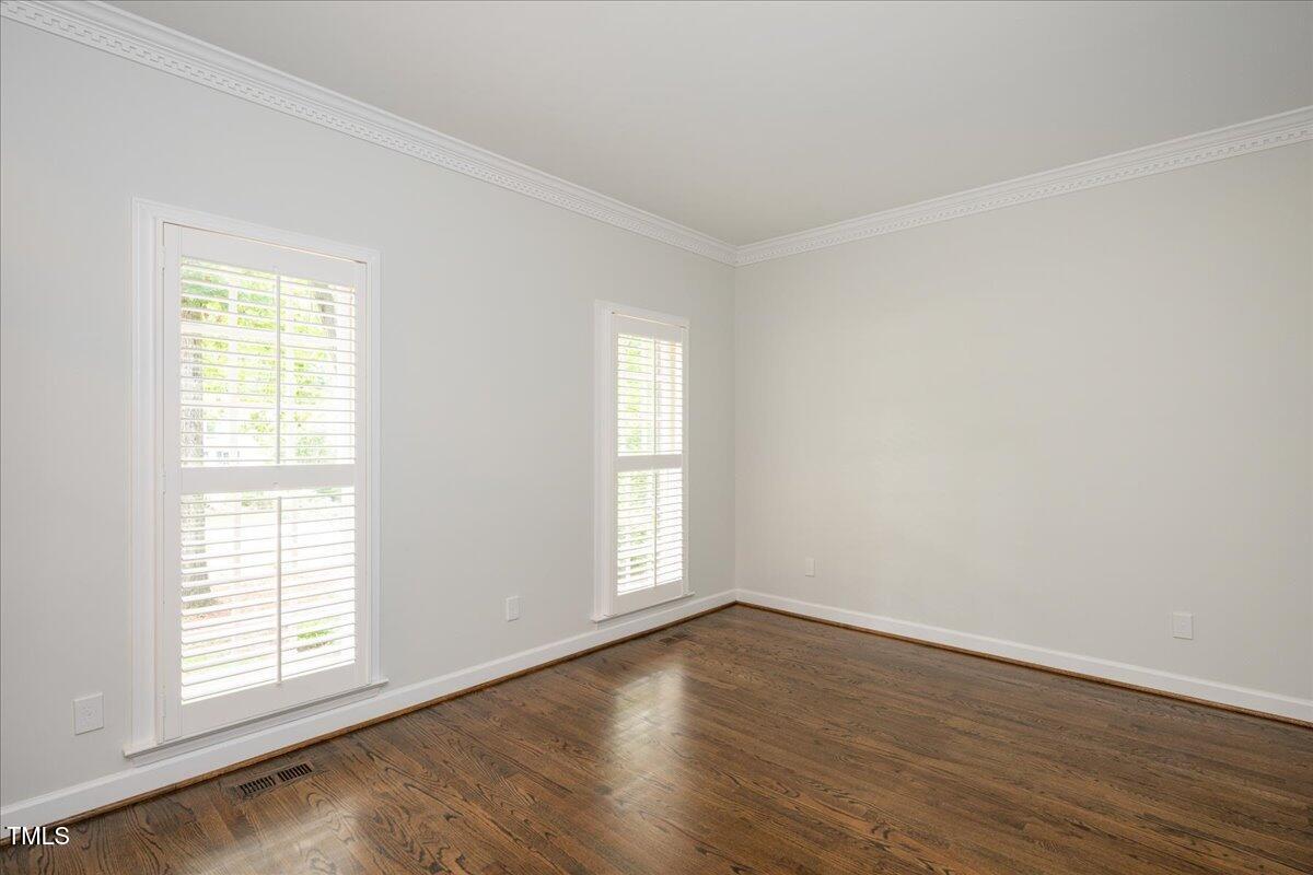 9228 Oneal Road Raleigh, NC 27613 - Photo 16 of 45 an empty room with wooden floor and windows