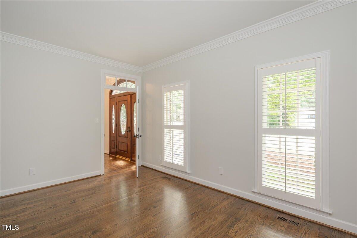 9228 Oneal Road Raleigh, NC 27613 - Photo 24 of 45 an empty room with wooden floor and windows