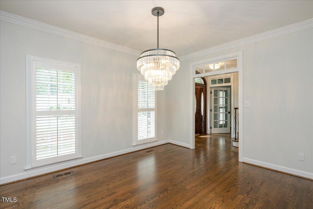 9228 Oneal Road Raleigh, NC 27613 - Photo 26 of 45 an empty room with wooden floor fan and windows