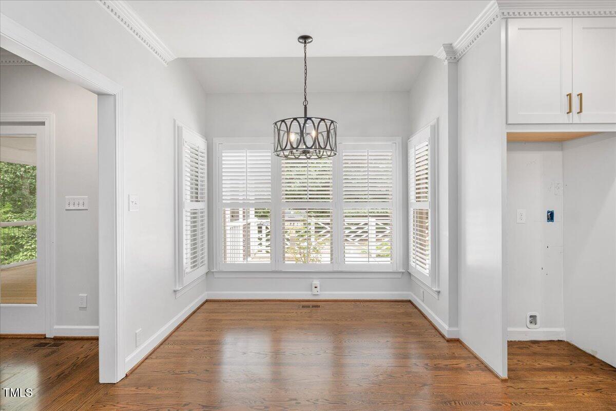 9228 Oneal Road Raleigh, NC 27613 - Photo 27 of 45 a view of an empty room with wooden floor and a window