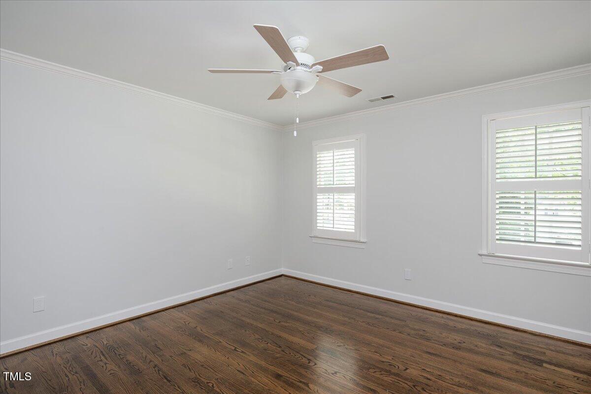 9228 Oneal Road Raleigh, NC 27613 - Photo 32 of 45 an empty room with wooden floor fan and windows