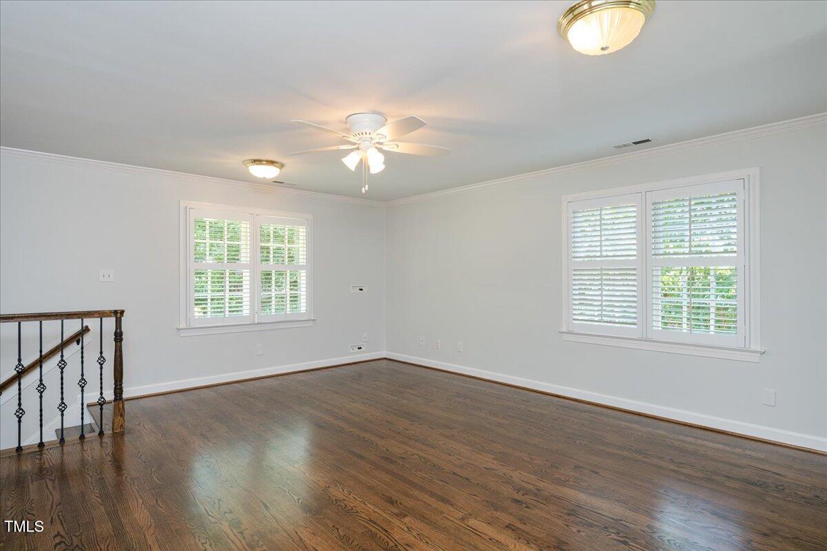 9228 Oneal Road Raleigh, NC 27613 - Photo 36 of 45 an empty room with wooden floor and windows