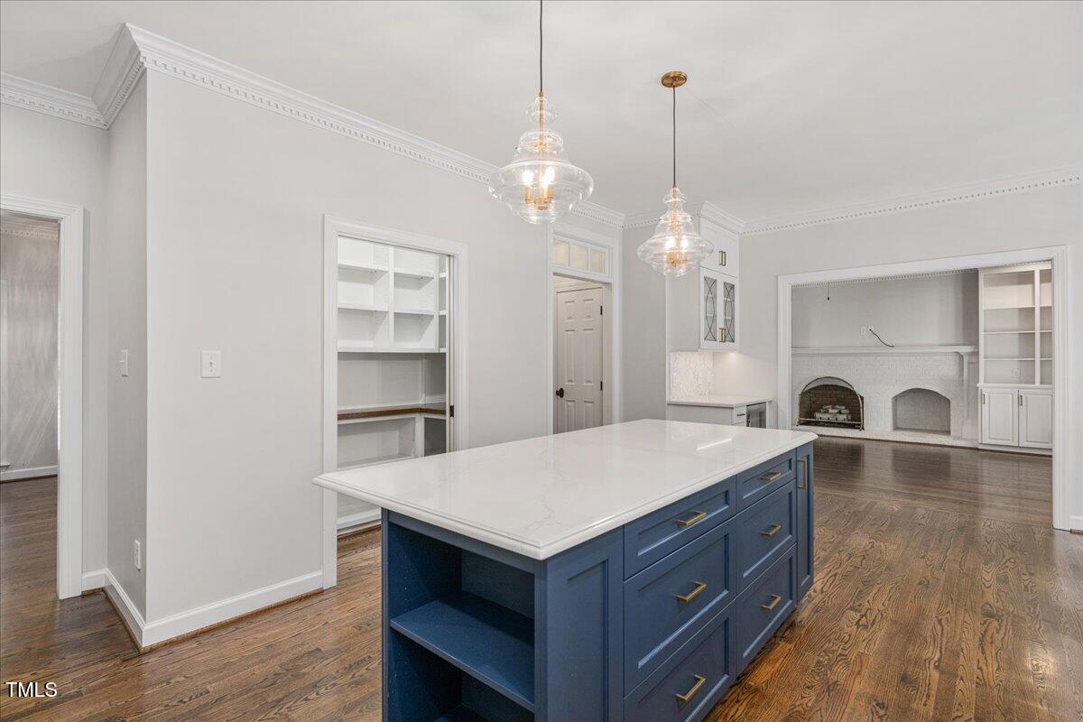 9228 Oneal Road Raleigh, NC 27613 - Photo 4 of 45 a living room with kitchen island furniture and a chandelier