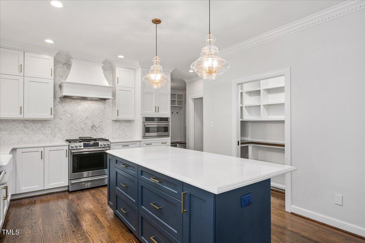 9228 Oneal Road Raleigh, NC 27613 - Photo 5 of 45 a kitchen with a stove and a kitchen island