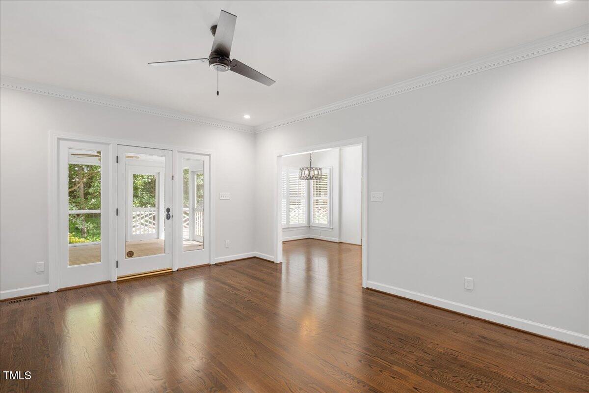 9228 Oneal Road Raleigh, NC 27613 - Photo 8 of 45 a view of an empty room with wooden floor and a window