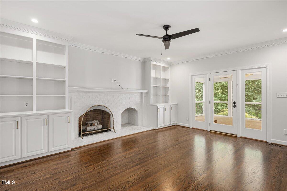 9228 Oneal Road Raleigh, NC 27613 - Photo 9 of 45 a view of a livingroom with a fireplace wooden floor and windows