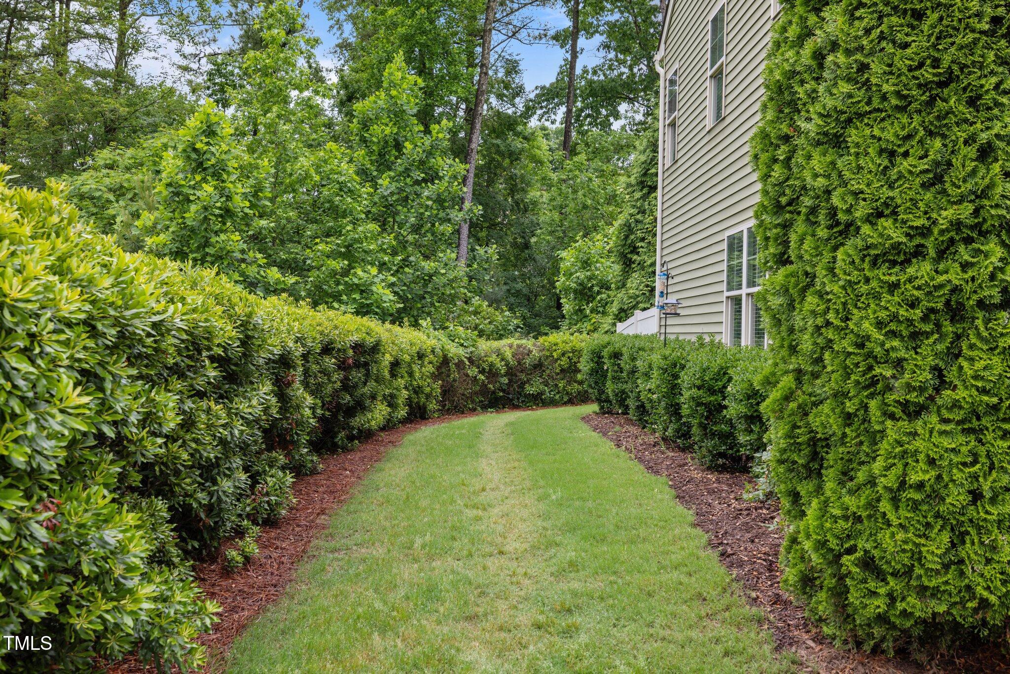 7871 Allscott Way Raleigh, NC 27612 - Photo 26 of 32 Easy access on side of home to back patio area. A perfect spot for a game of corn hole!