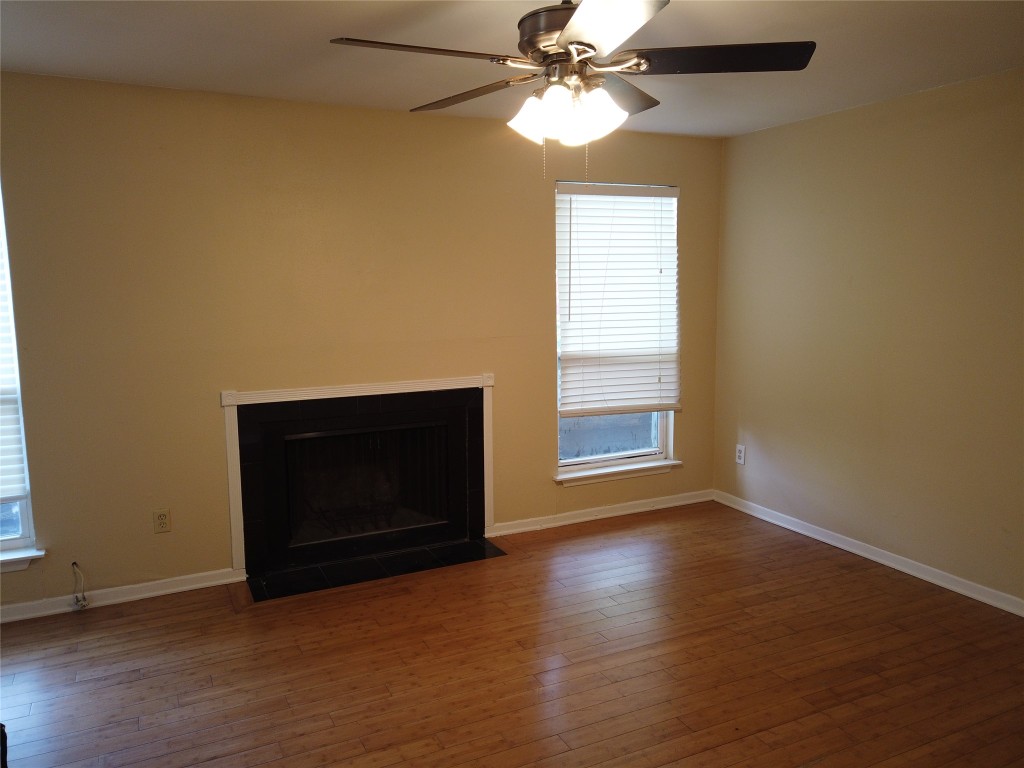 1000 West 26th Street, Unit 110 Austin, TX 78705 - Photo 2 of 12 a view of an empty room with wooden floor and a window
