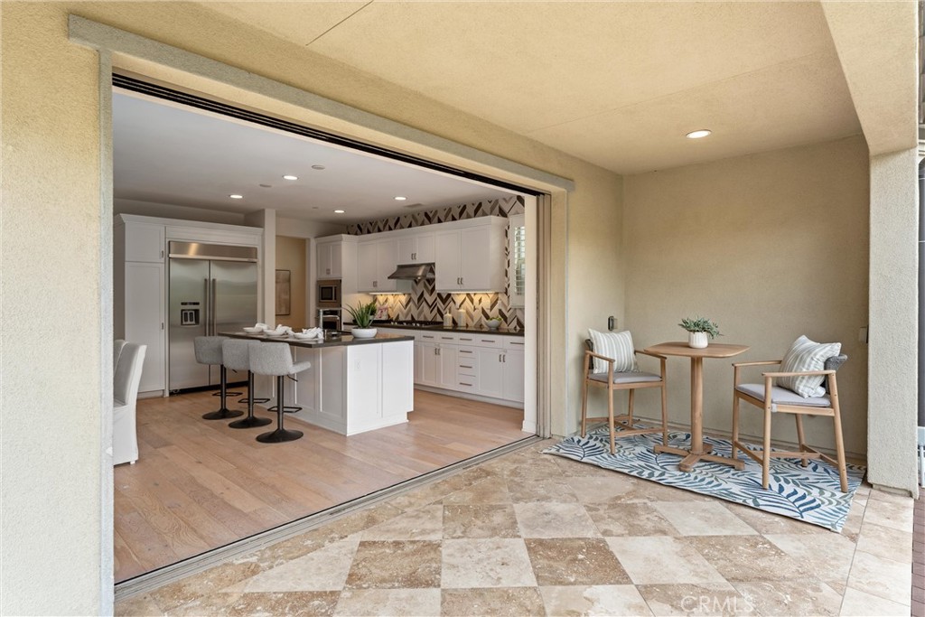 287 Barnes Road Tustin, CA 92782 - Photo 17 of 54 a living room with furniture and a dining table with kitchen view