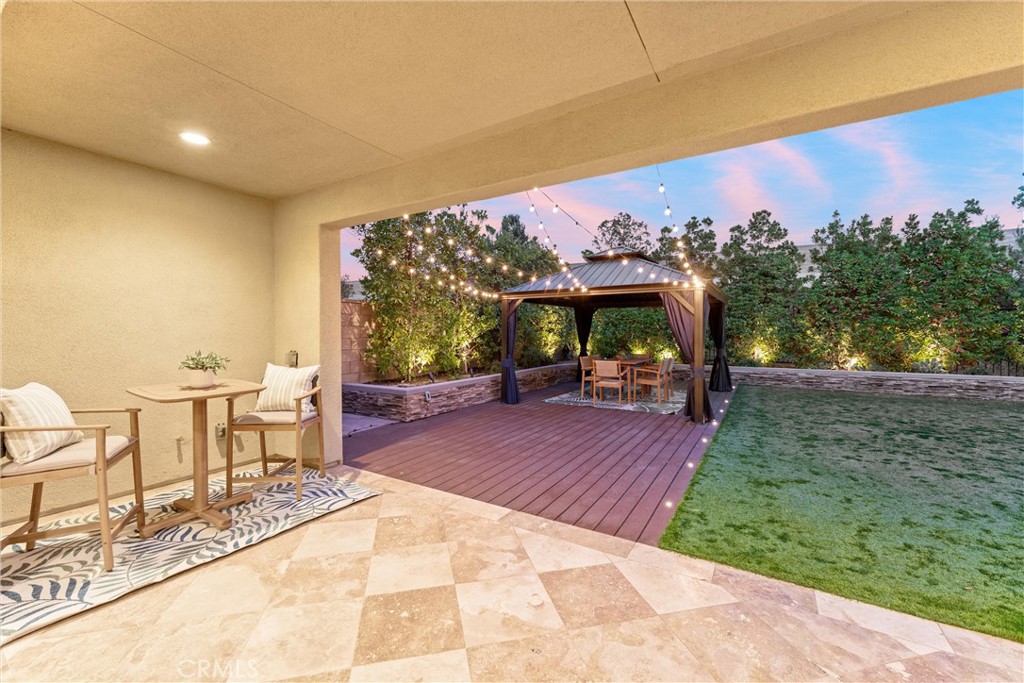 287 Barnes Road Tustin, CA 92782 - Photo 20 of 54 a view of a patio with table and chairs with wooden floor and fence