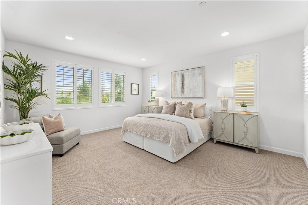 287 Barnes Road Tustin, CA 92782 - Photo 27 of 54 a spacious bedroom with a bed and a couch