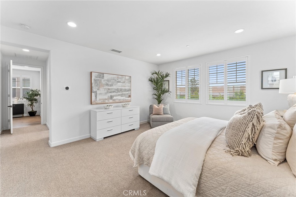 287 Barnes Road Tustin, CA 92782 - Photo 28 of 54 a spacious bedroom with a bed a couch and large window