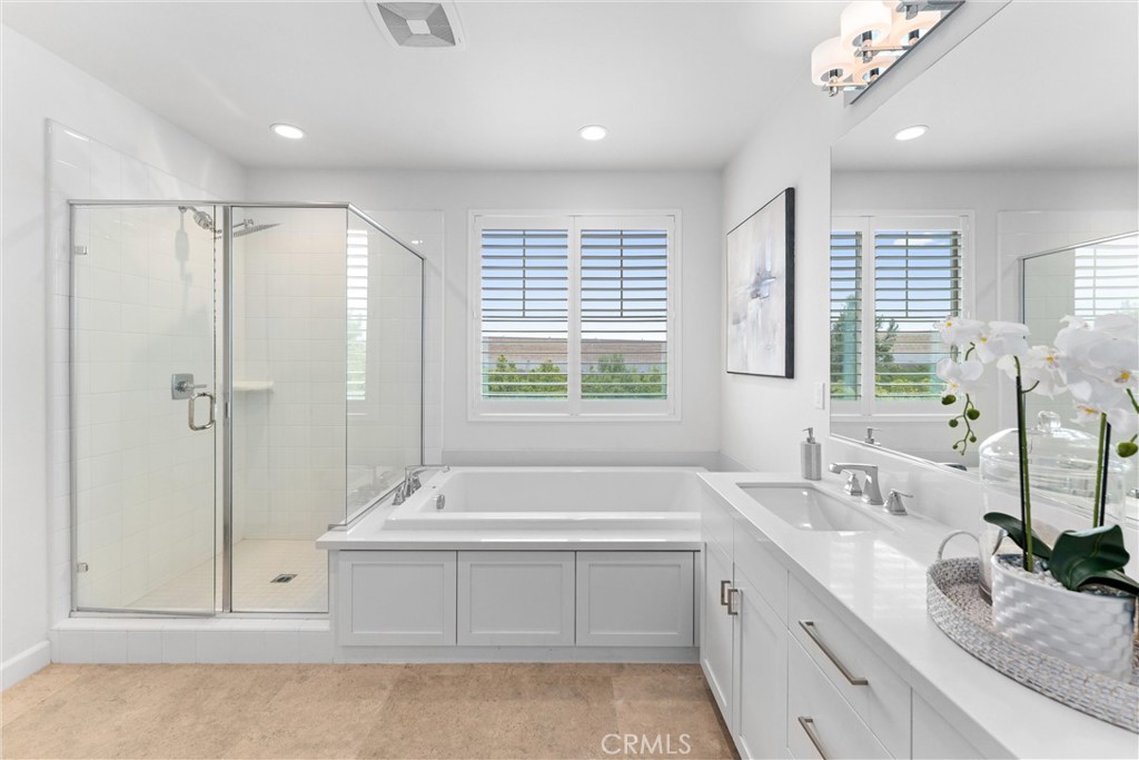 287 Barnes Road Tustin, CA 92782 - Photo 30 of 54 a bathroom with a tub sink and mirror