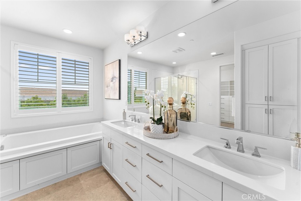 287 Barnes Road Tustin, CA 92782 - Photo 31 of 54 a bathroom with a sink double vanity granite tub shower and a mirror