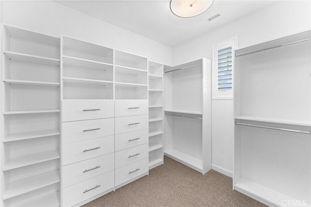 287 Barnes Road Tustin, CA 92782 - Photo 32 of 54 a view of walk in closet with empty racks