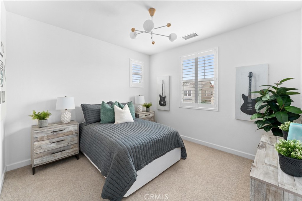 287 Barnes Road Tustin, CA 92782 - Photo 34 of 54 a bedroom with a bed chandelier and a window