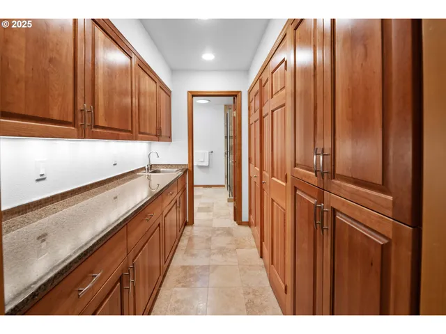 a view of hallway with cabinets