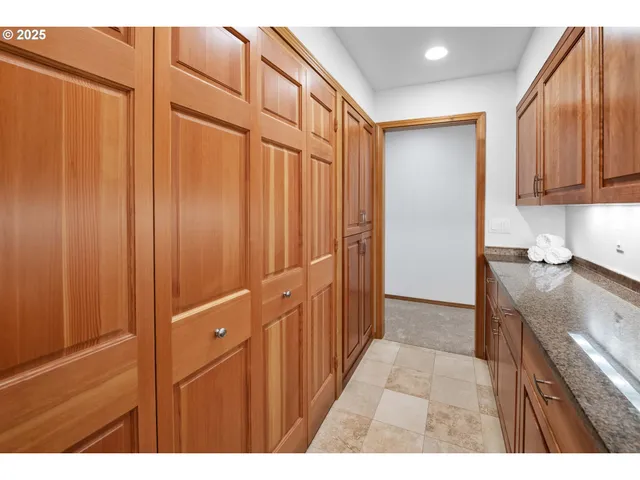 a spacious bathroom with a double vanity sink a mirror and a shower