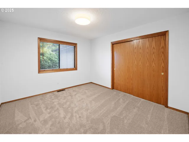 a view of an empty room and a window