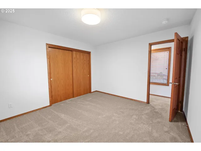 a bedroom with a bed and a lamp