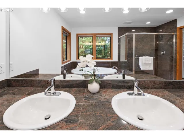 a bathroom with a glass shower door