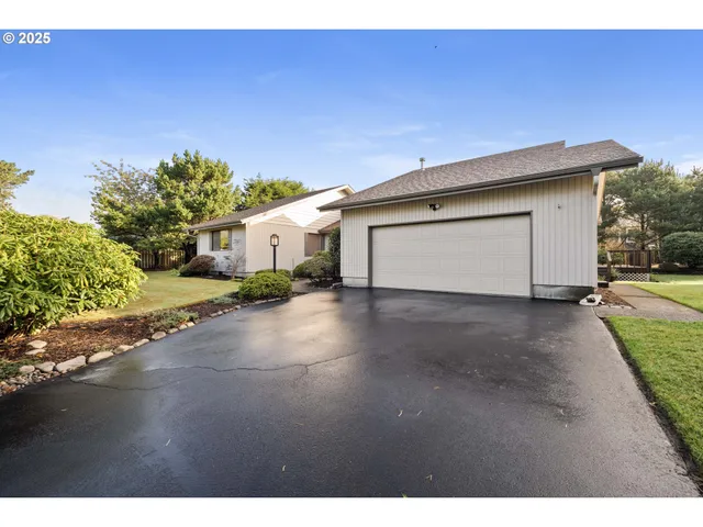an aerial view of a house with a yard and garden
