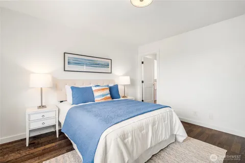 a bedroom with a bed and a lamp