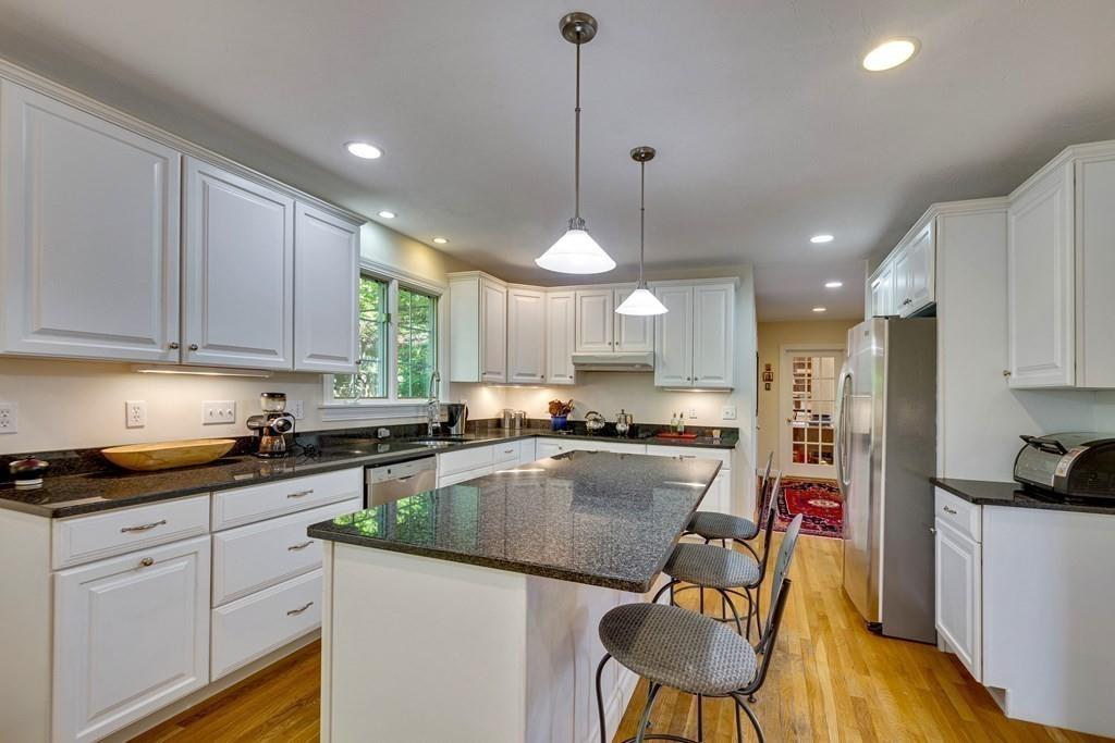 65 Wachusett Road Needham, MA 02492 - Photo 16 of 42 a kitchen with a refrigerator a stove a sink dishwasher and white cabinets with wooden floor