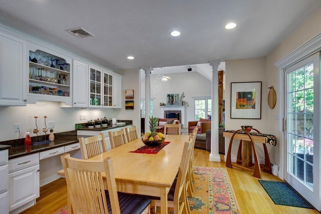 65 Wachusett Road Needham, MA 02492 - Photo 18 of 42 a large kitchen with stainless steel appliances granite countertop a stove top oven a sink a dining table and chairs with wooden floor