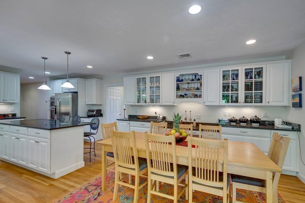 65 Wachusett Road Needham, MA 02492 - Photo 19 of 42 a kitchen with stainless steel appliances granite countertop a sink a stove a dining table and chairs
