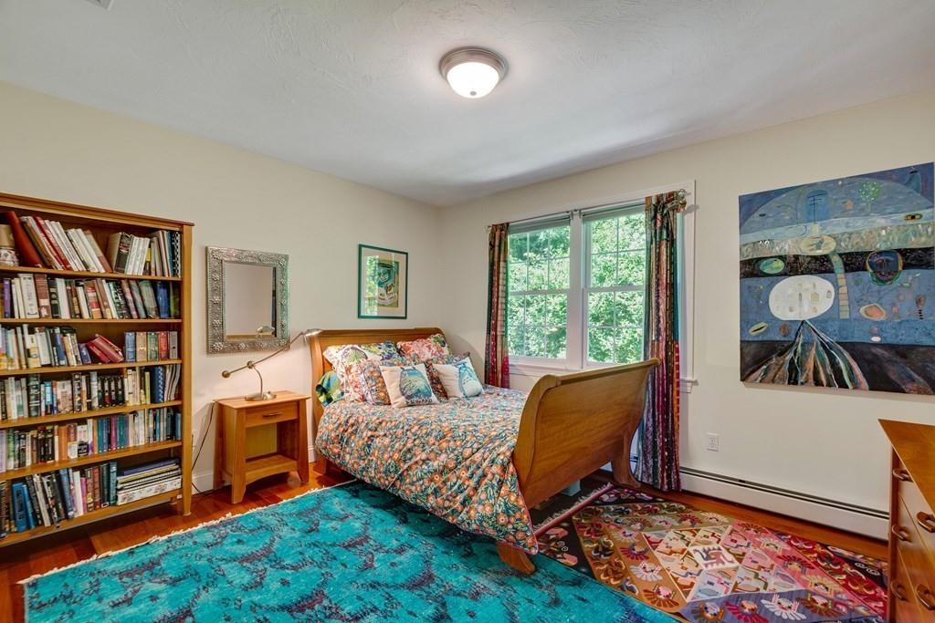 65 Wachusett Road Needham, MA 02492 - Photo 30 of 42 a bed room with a bed and a book shelf