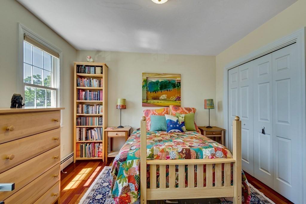 65 Wachusett Road Needham, MA 02492 - Photo 32 of 42 a bedroom with a bed and a book shelf