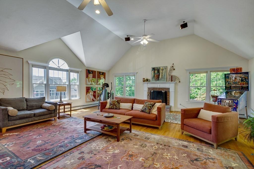 65 Wachusett Road Needham, MA 02492 - Photo 9 of 42 a living room with furniture a fireplace and a large window