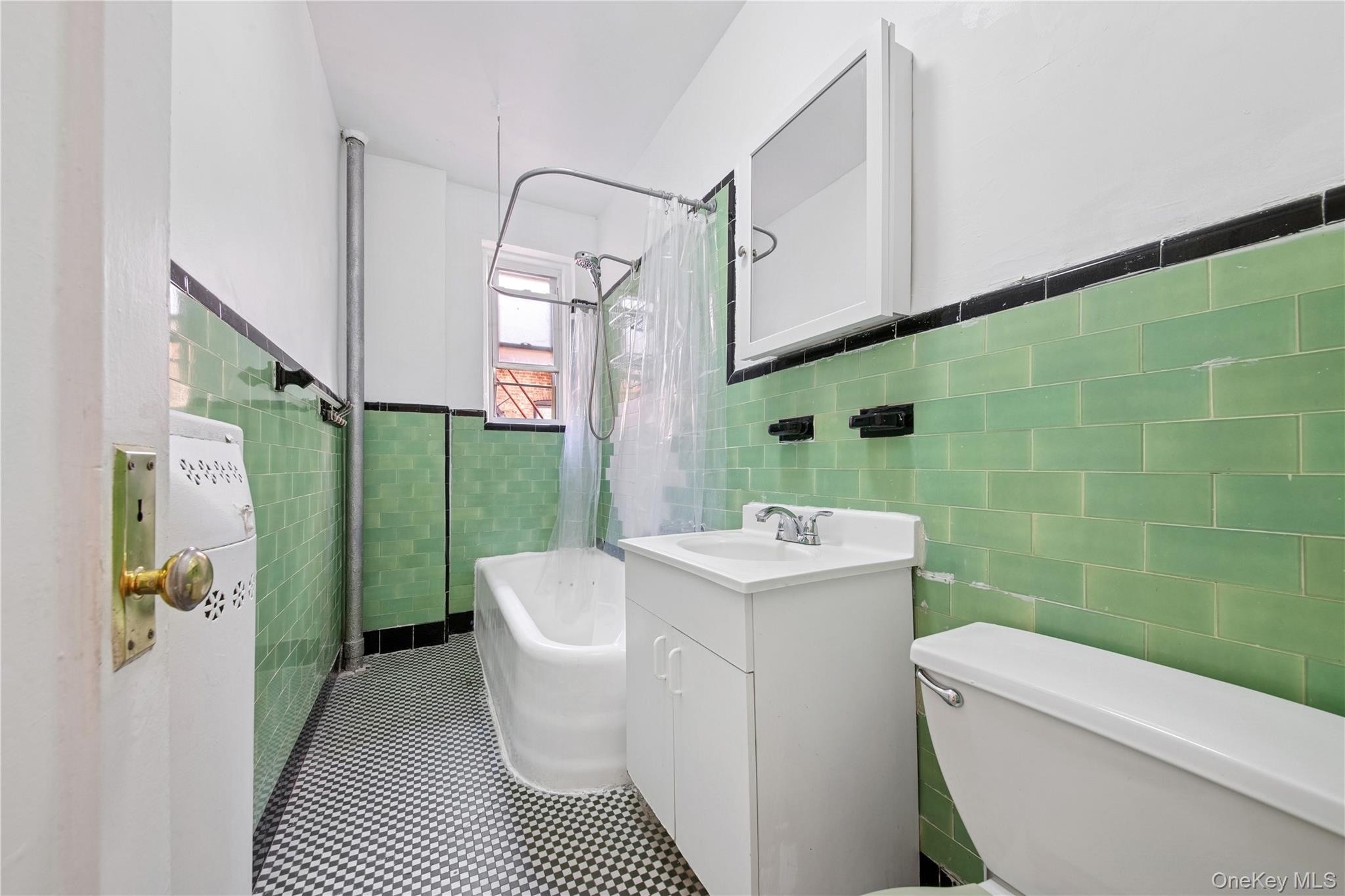 41-25 44th Street, Unit C5 Queens, NY 11104 - Photo 12 of 14 a bathroom with a sink a toilet and a shower