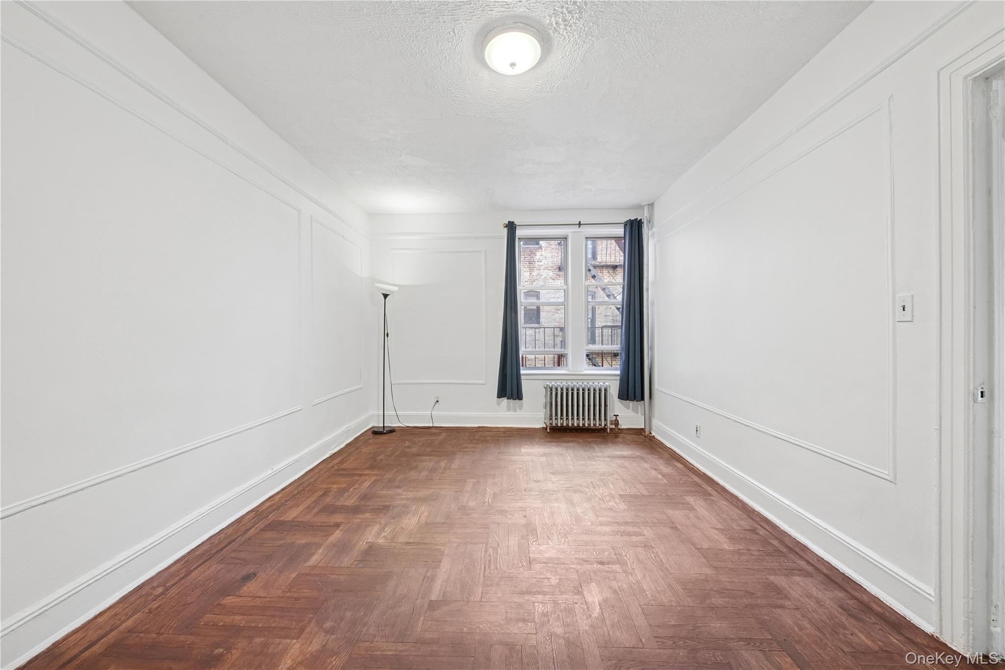 41-25 44th Street, Unit C5 Queens, NY 11104 - Photo 7 of 14 an empty room with closet and windows