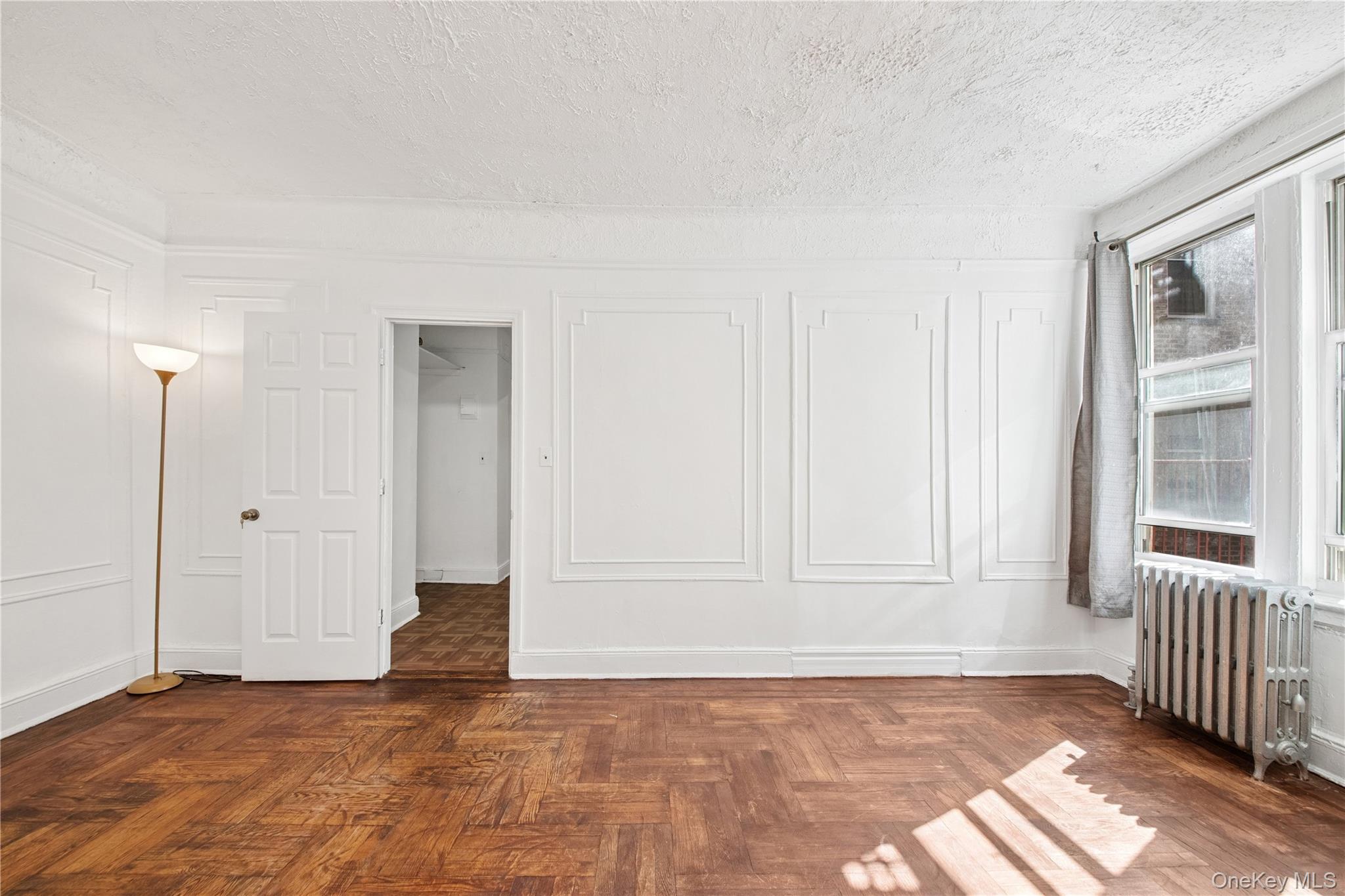 41-25 44th Street, Unit C5 Queens, NY 11104 - Photo 8 of 14 a view of an empty room with wooden floor and a window