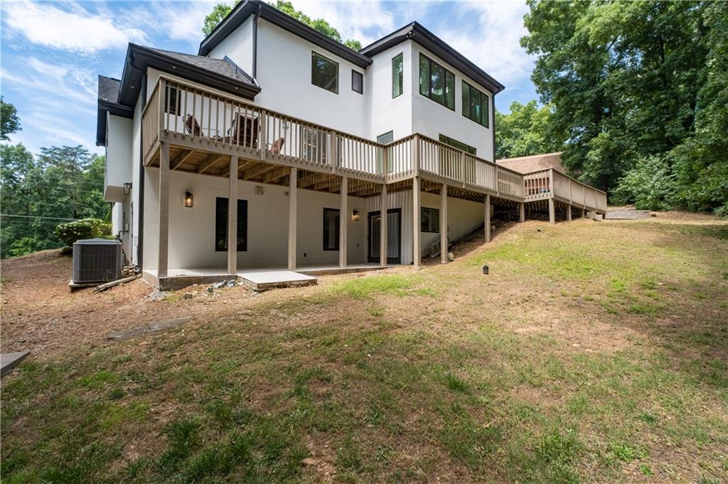 4610 West Morton Road Alpharetta, GA 30022 - Photo 48 of 53 a view of a white house with large windows and a small yard