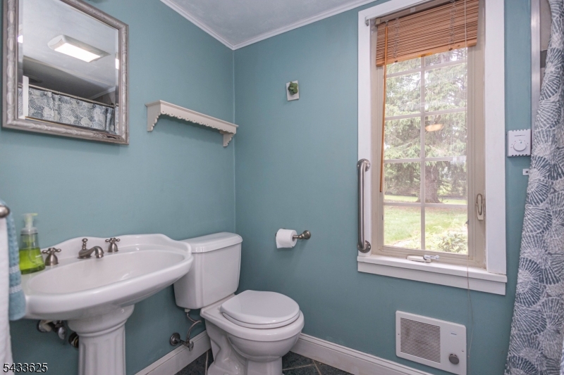 449 Stamets Road Milford, NJ 08848 - Photo 23 of 44 a bathroom with a sink a toilet and a mirror