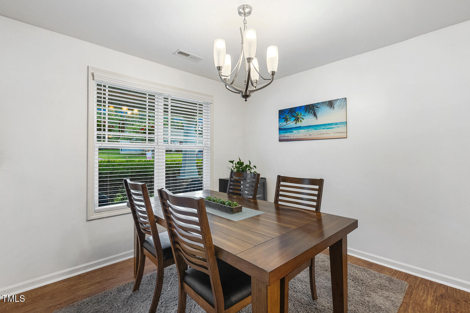 131 Abacos Court Clayton, NC 27520 - Photo 11 of 39 a view of a dining room with furniture wooden floor and a chandelier