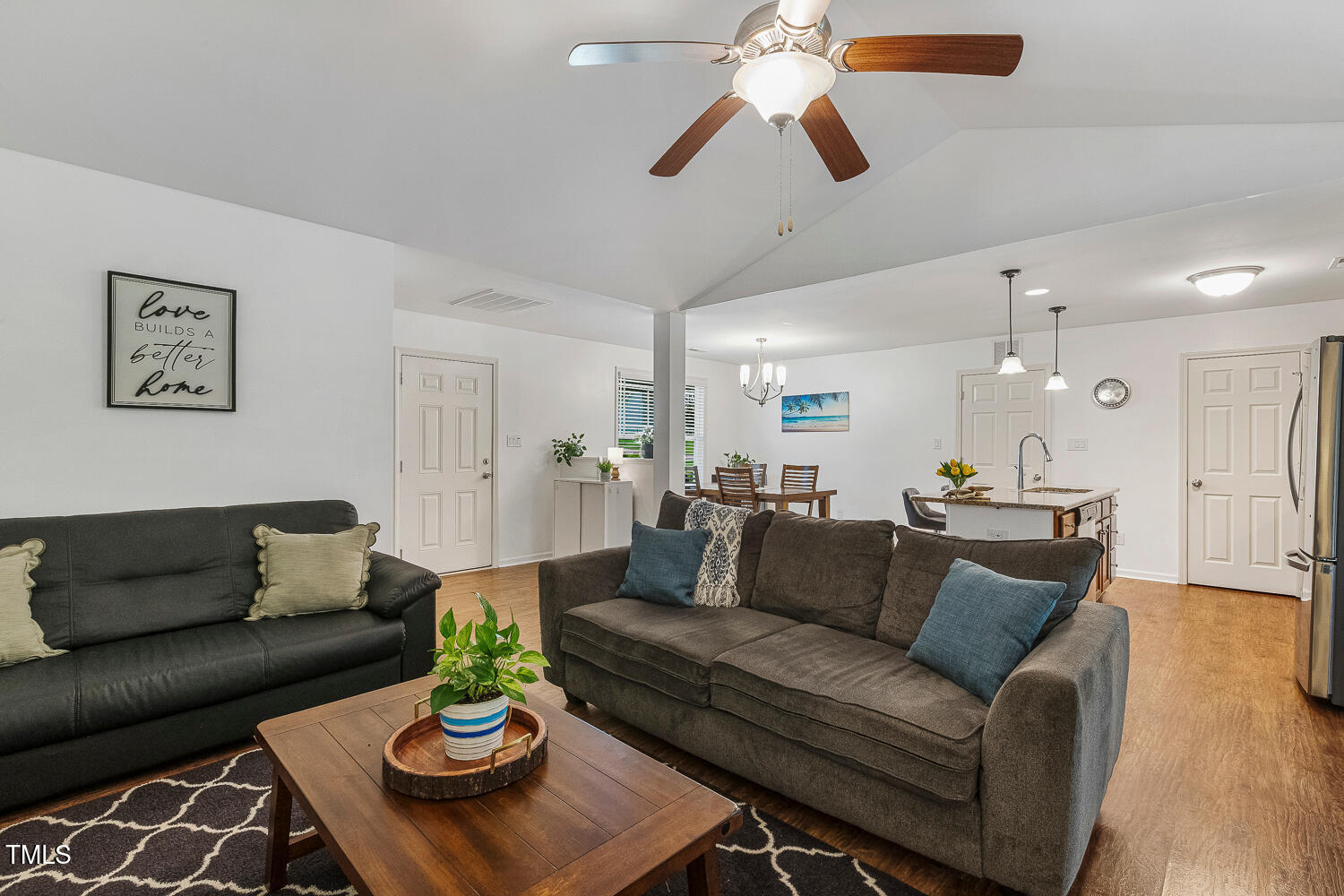 131 Abacos Court Clayton, NC 27520 - Photo 15 of 39 a living room with furniture kitchen view and a chandelier