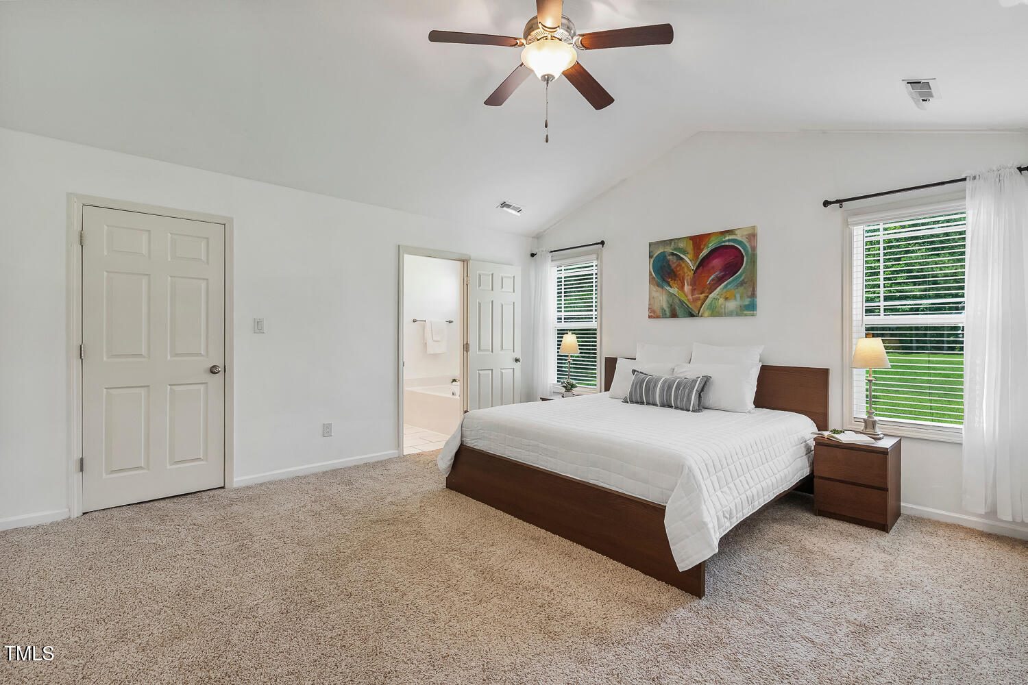 131 Abacos Court Clayton, NC 27520 - Photo 17 of 39 a spacious bedroom with a bed and a chandelier