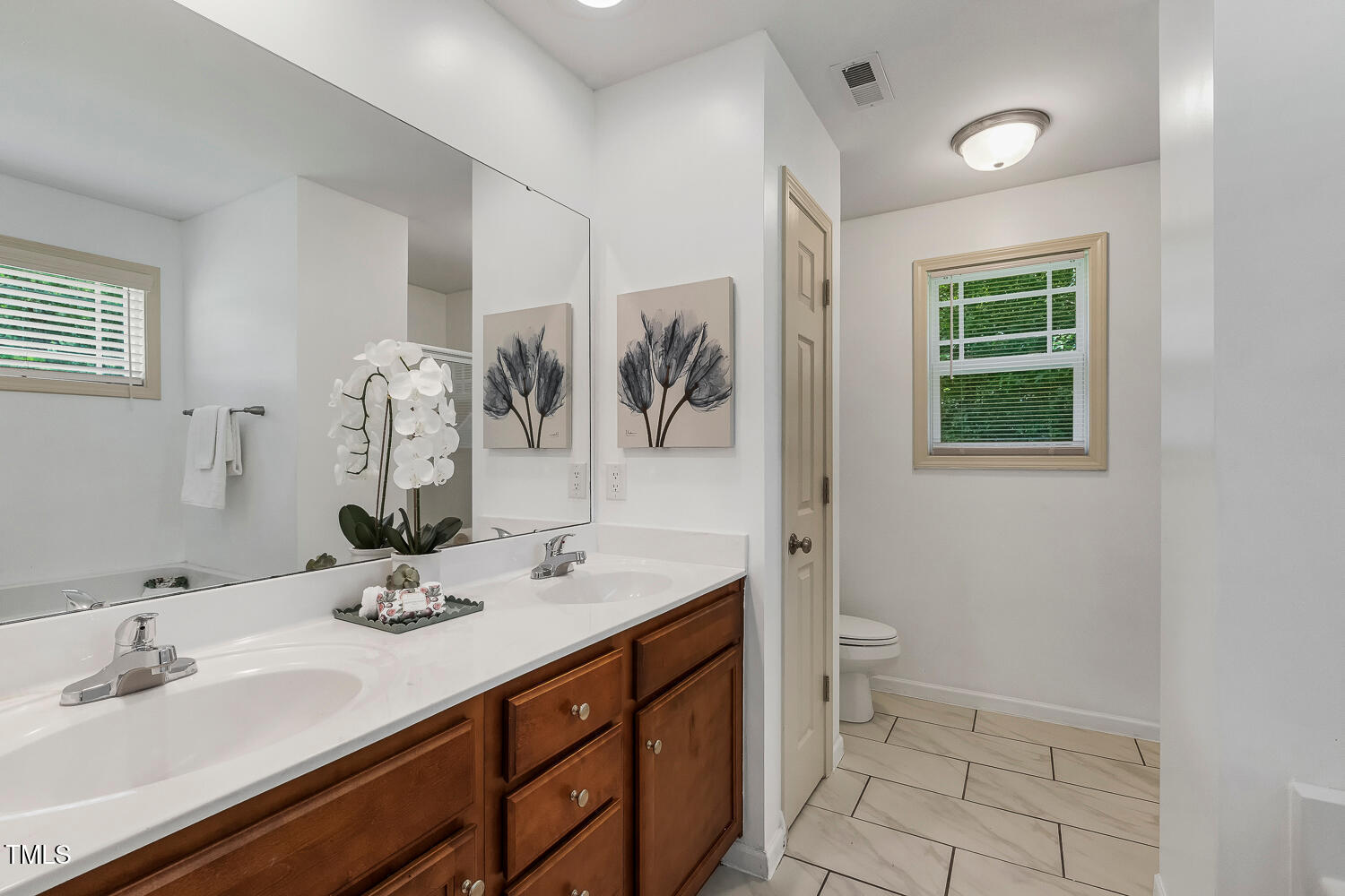 131 Abacos Court Clayton, NC 27520 - Photo 20 of 39 a bathroom with a double vanity sink toilet and a mirror
