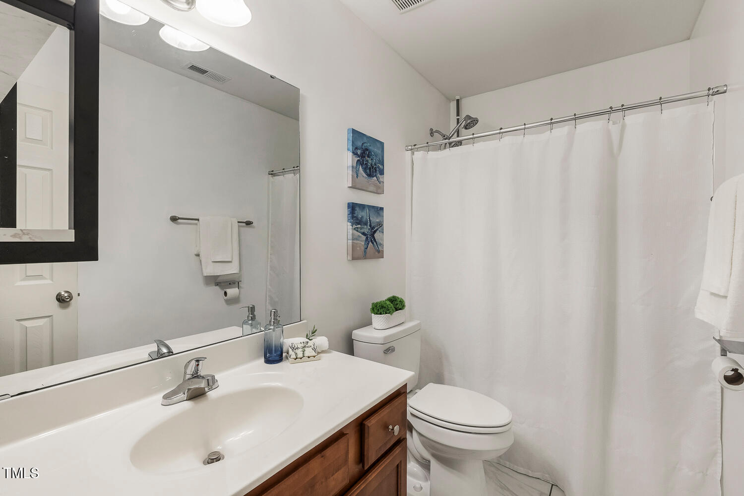 131 Abacos Court Clayton, NC 27520 - Photo 25 of 39 a bathroom with a sink toilet and a mirror