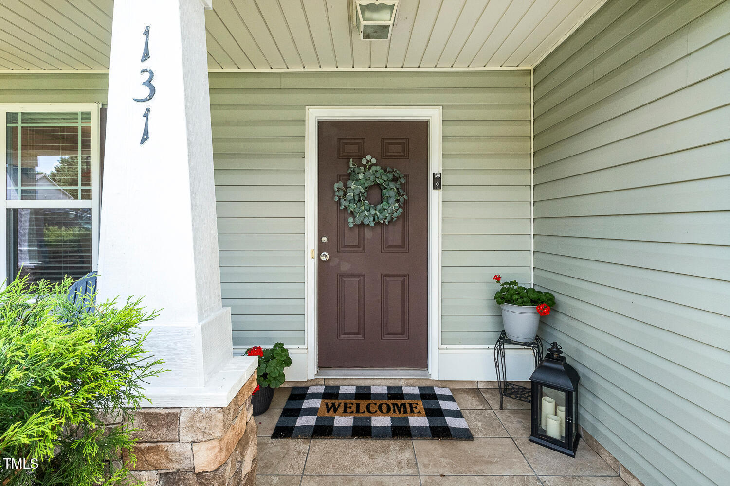 131 Abacos Court Clayton, NC 27520 - Photo 4 of 39 a house with a potted plant and a potted plant