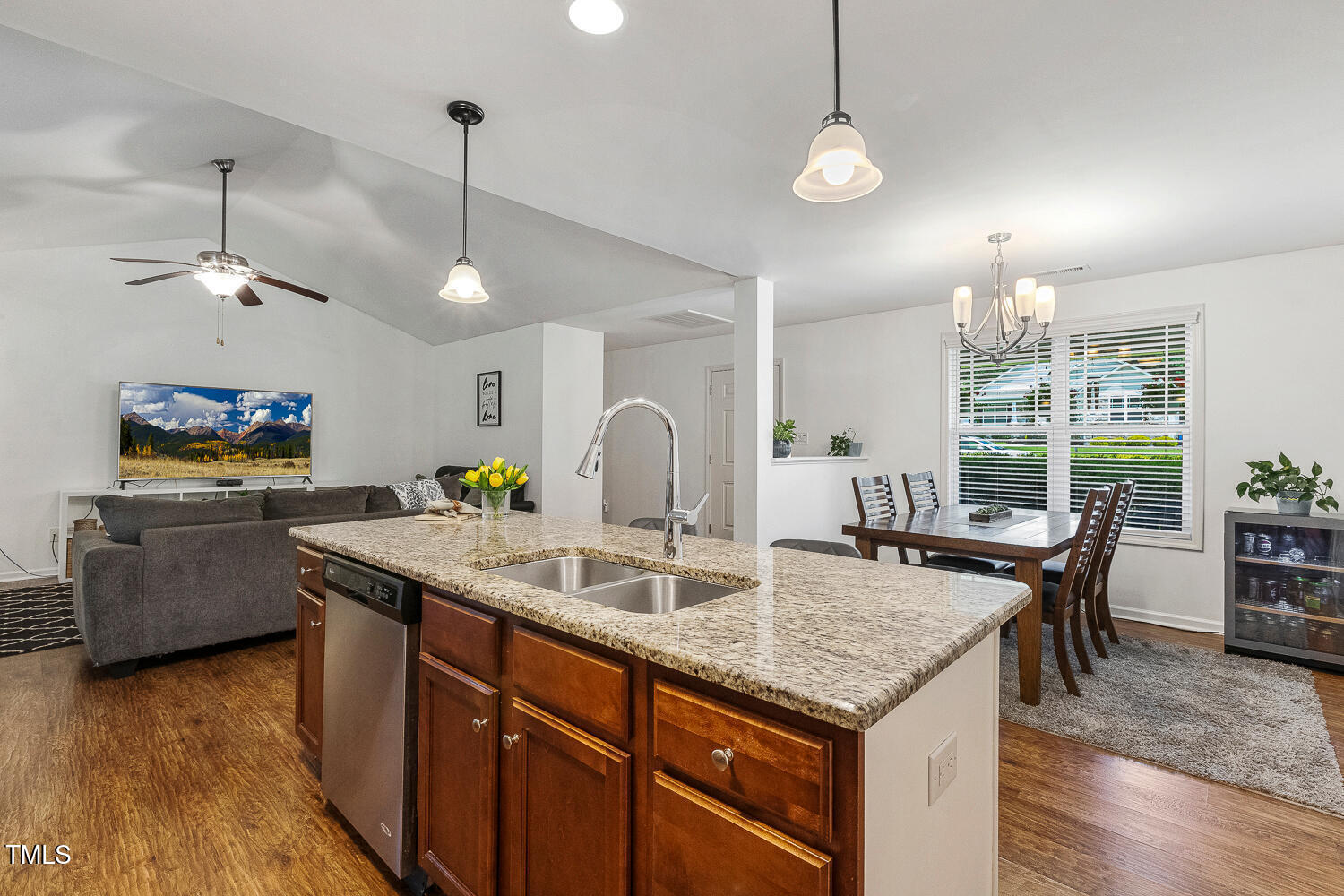 131 Abacos Court Clayton, NC 27520 - Photo 8 of 39 a kitchen with granite countertop a sink a counter space appliances and living room view