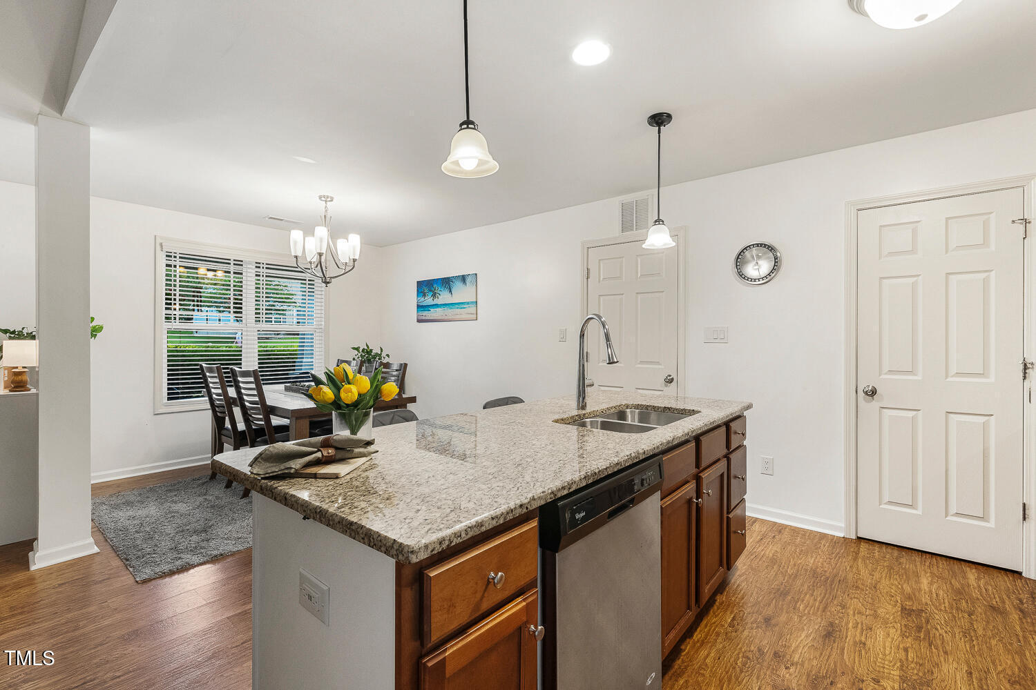 131 Abacos Court Clayton, NC 27520 - Photo 9 of 39 a kitchen with stainless steel appliances granite countertop a sink a stove and a wooden floors
