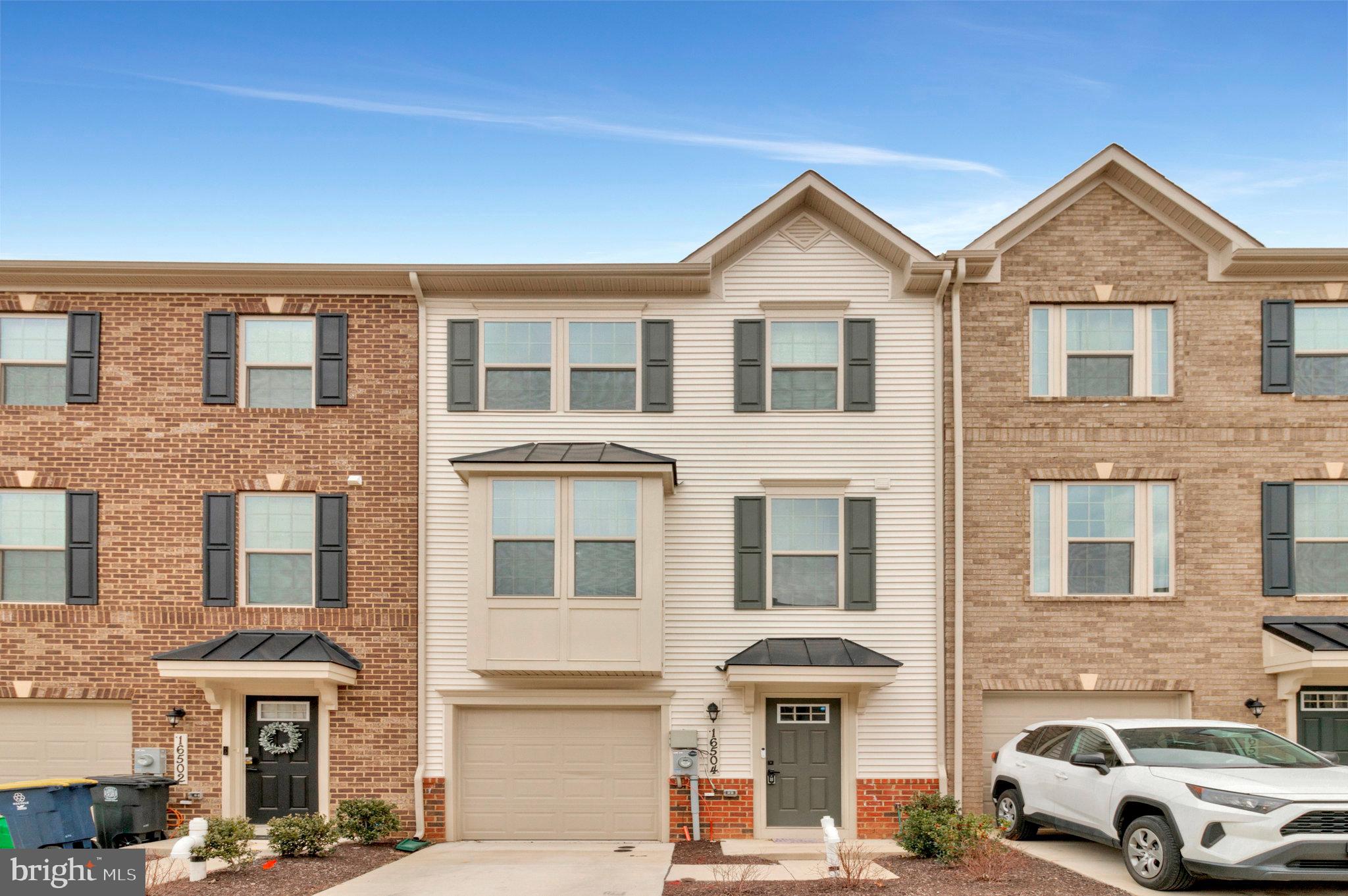 a front view of a residential apartment building with a yard