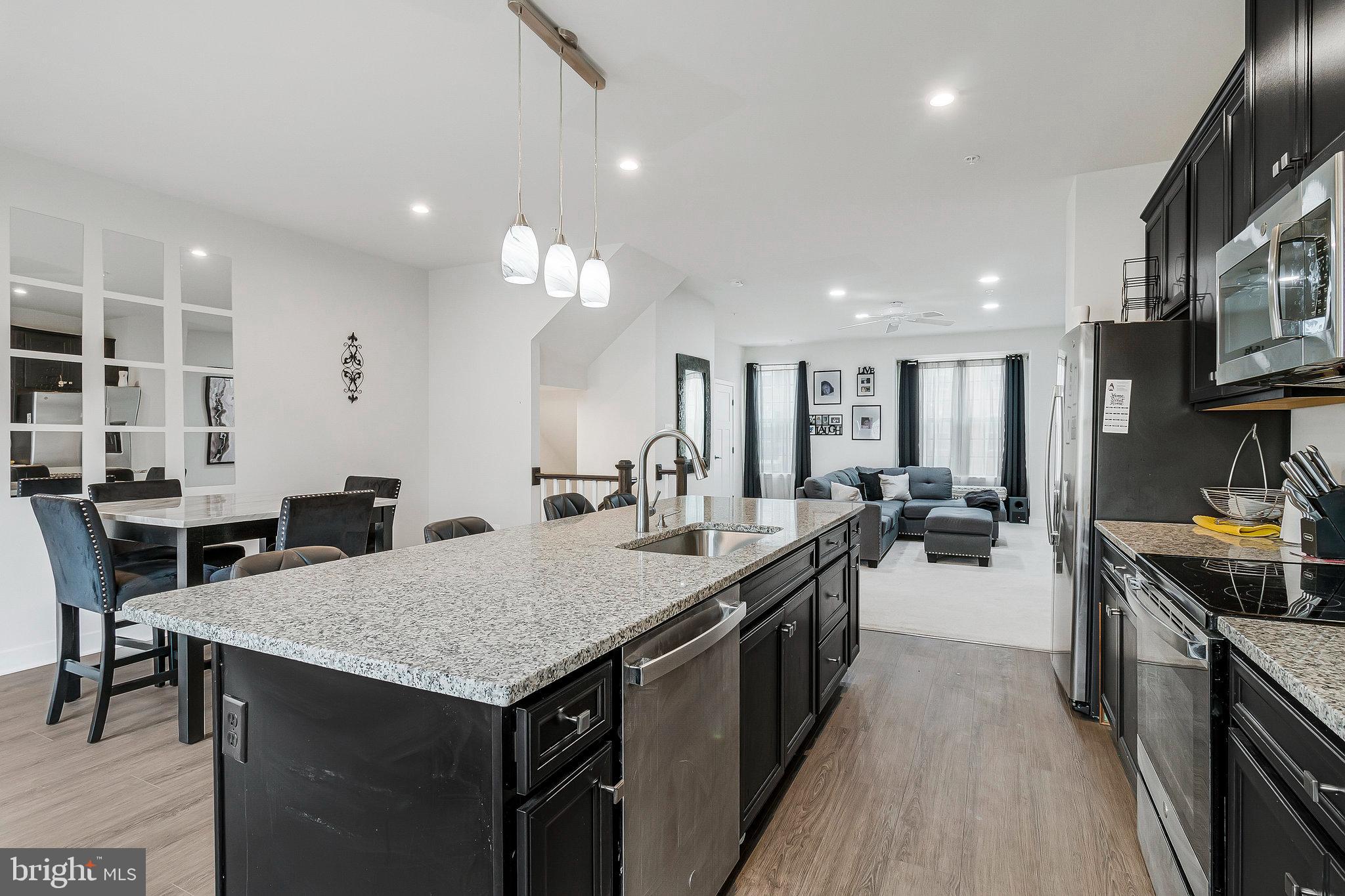 16504 Caribbean Way Accokeek, MD 20607 - Photo 11 of 29 a kitchen with sink stove and chairs