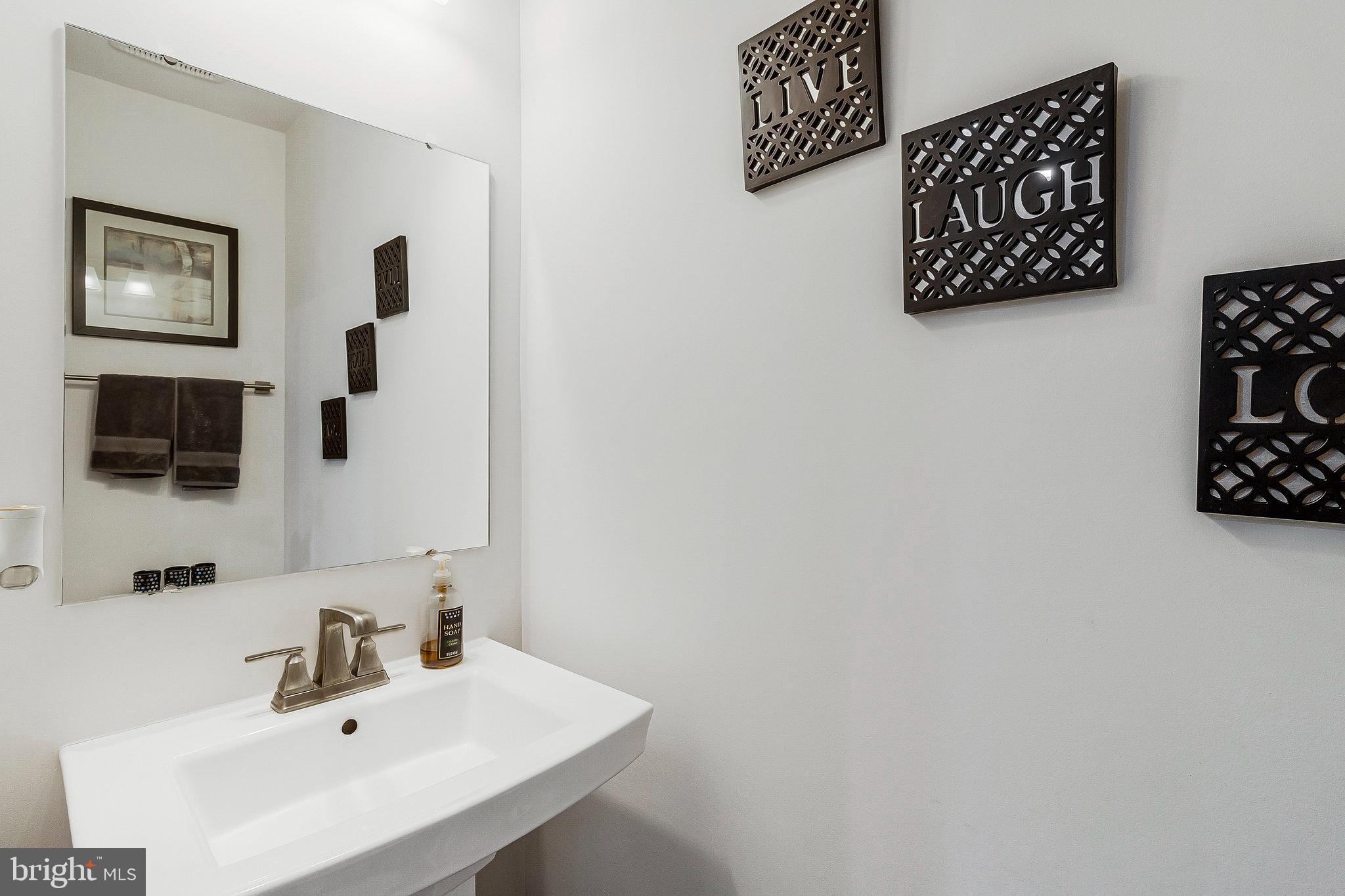 16504 Caribbean Way Accokeek, MD 20607 - Photo 12 of 29 a bathroom with a sink and a mirror