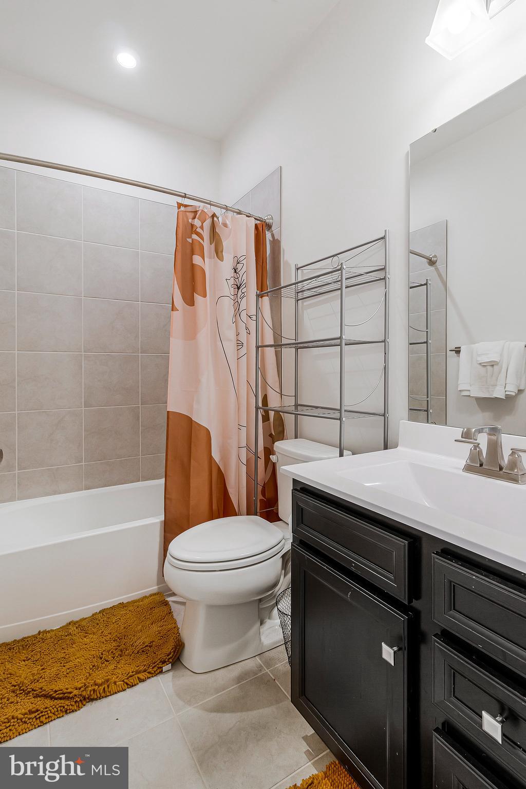 16504 Caribbean Way Accokeek, MD 20607 - Photo 18 of 29 a bathroom with a sink toilet and shower